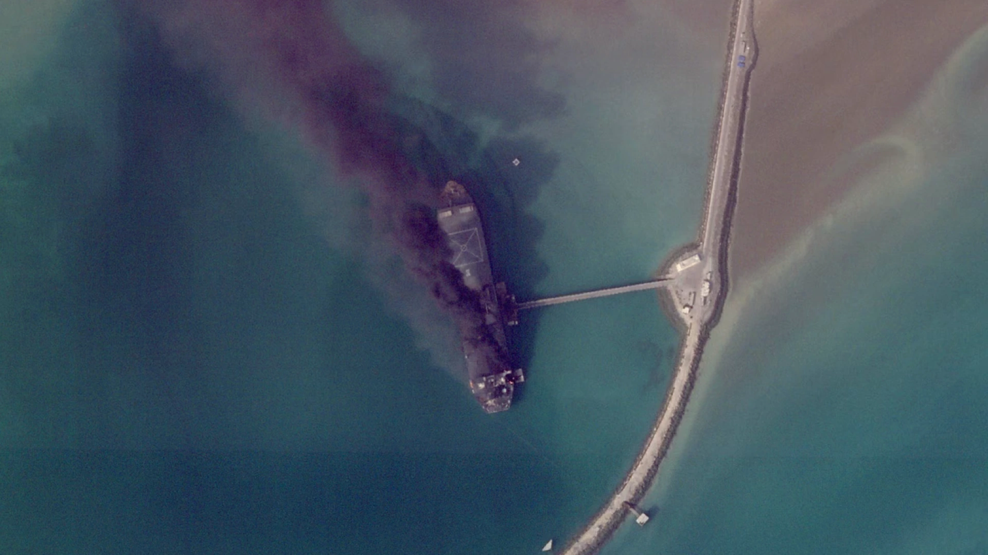 A ship in an Iranian port burns after a U.S. strike.